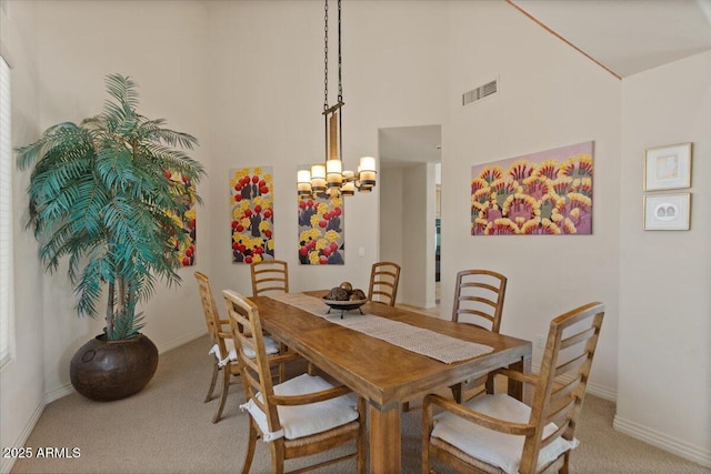 9432 N Longfeather, Fountain Hills, AZ 85268 - dining room featuring light colored carpet, a chandelier, baseboards, and a towering ceiling