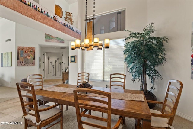9432 N Longfeather, Fountain Hills, AZ 85268 - dining space featuring a chandelier, light colored carpet, baseboards, and a towering ceiling