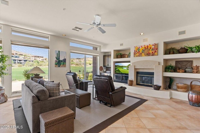 9432 N Longfeather, Fountain Hills, AZ 85268 - living room with built in shelves, plenty of natural light, a ceiling fan, light tile patterned flooring, and recessed lighting