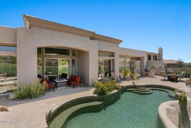 9432 N Longfeather, Fountain Hills, AZ 85268 - back of property featuring a patio area, stucco siding, an outdoor fire pit, and fence