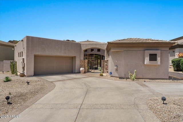 9432 N Longfeather, Fountain Hills, AZ 85268 - pueblo-style home featuring stucco siding, a garage, and driveway