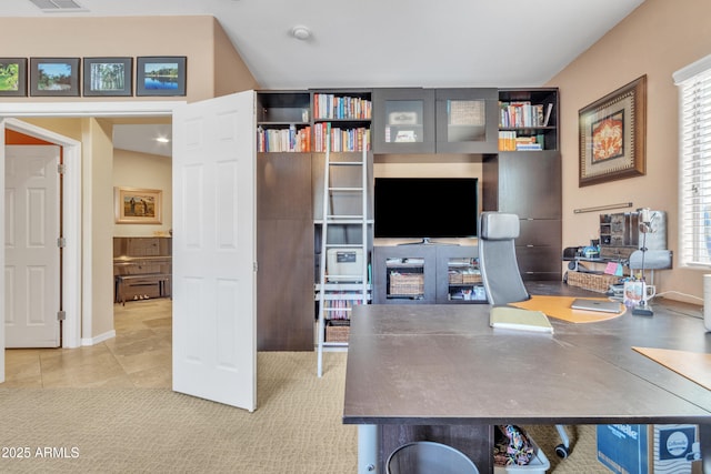 office area featuring carpet floors, visible vents, and tile patterned floors