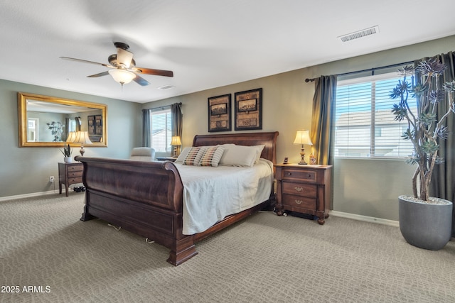 bedroom with baseboards, ceiling fan, visible vents, and light colored carpet