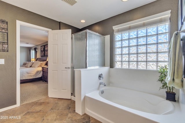 ensuite bathroom featuring visible vents, a shower stall, a bath, and ensuite bathroom