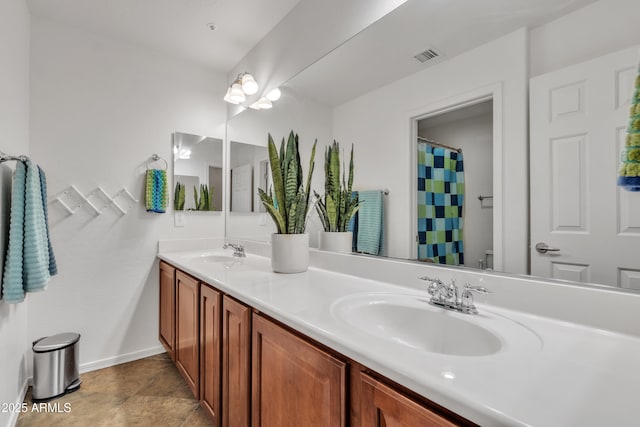 bathroom with curtained shower, visible vents, a sink, and double vanity