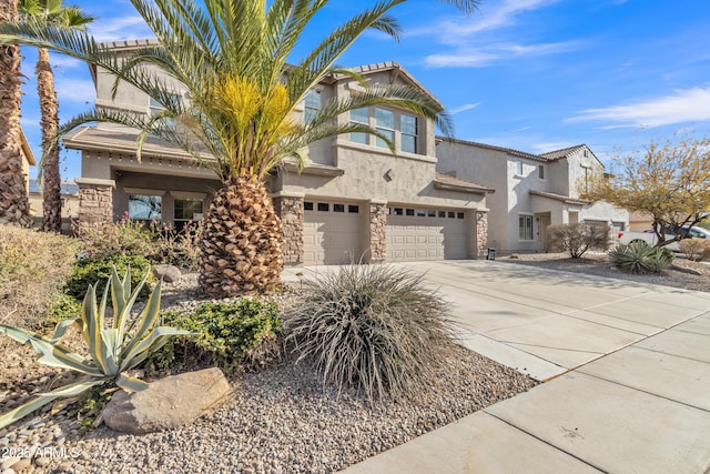 view of front of property with stone siding, concrete driveway, an attached garage, and stucco siding