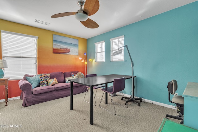 office space with a ceiling fan, baseboards, visible vents, and carpet flooring