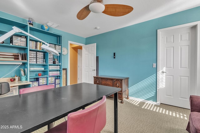 home office with carpet flooring and a ceiling fan