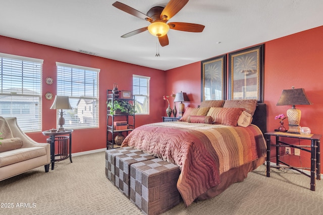 carpeted bedroom featuring visible vents, ceiling fan, and baseboards