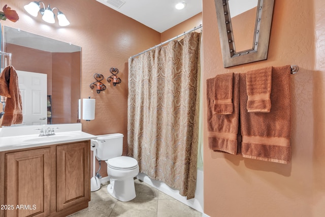 bathroom with visible vents, a textured wall, vanity, and toilet