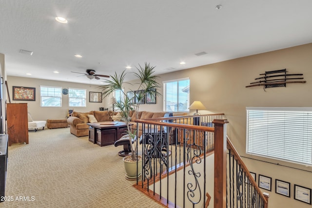 interior space featuring recessed lighting, carpet, an upstairs landing, and a healthy amount of sunlight