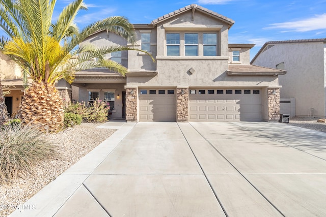 view of front facade featuring a garage, stone siding, driveway, and stucco siding