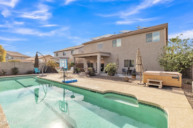 view of pool with a patio area, a fenced backyard, a fenced in pool, and a hot tub