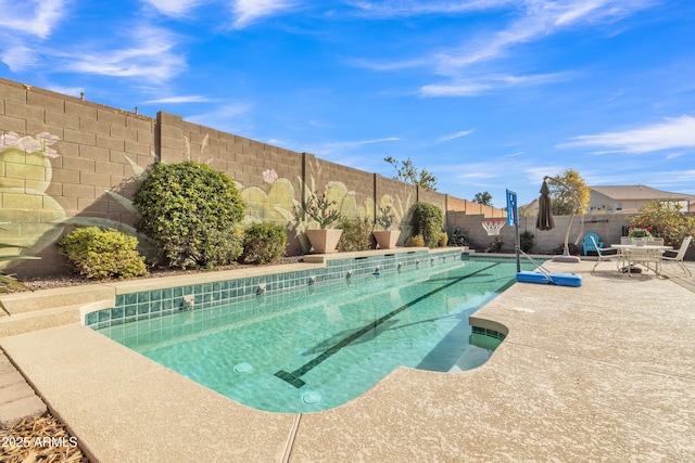 view of swimming pool featuring a fenced backyard, a fenced in pool, and a patio