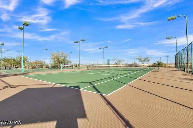 view of sport court featuring community basketball court and fence