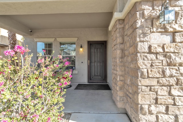 entrance to property featuring stucco siding