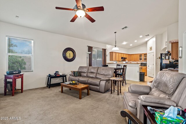 18057 W Port Royale Ln, Surprise, AZ 85388 - living room with a wealth of natural light, vaulted ceiling, a ceiling fan, light carpet, and visible vents