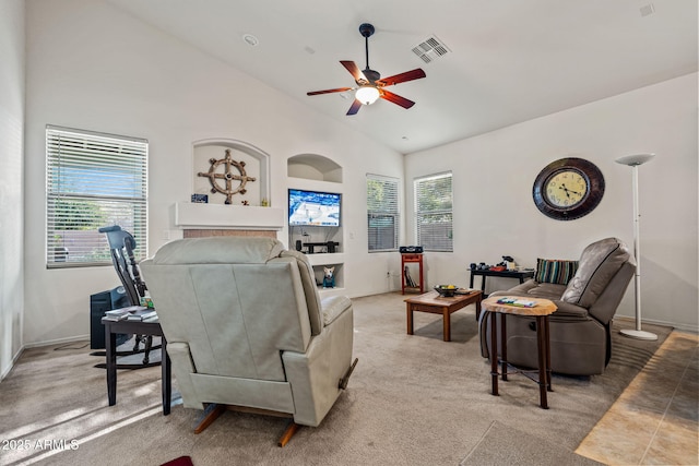 18057 W Port Royale Ln, Surprise, AZ 85388 - carpeted living room with high vaulted ceiling, ceiling fan, visible vents, and a healthy amount of sunlight