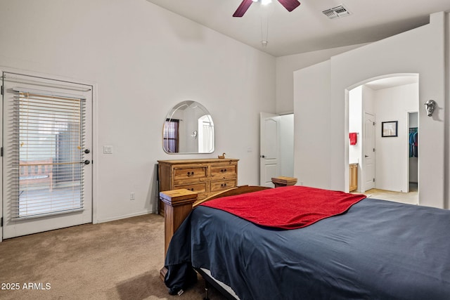 18057 W Port Royale Ln, Surprise, AZ 85388 - bedroom featuring light colored carpet, a high ceiling, arched walkways, connected bathroom, and visible vents