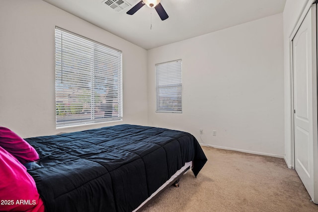 18057 W Port Royale Ln, Surprise, AZ 85388 - bedroom featuring a closet, carpet flooring, visible vents, baseboards, and a ceiling fan