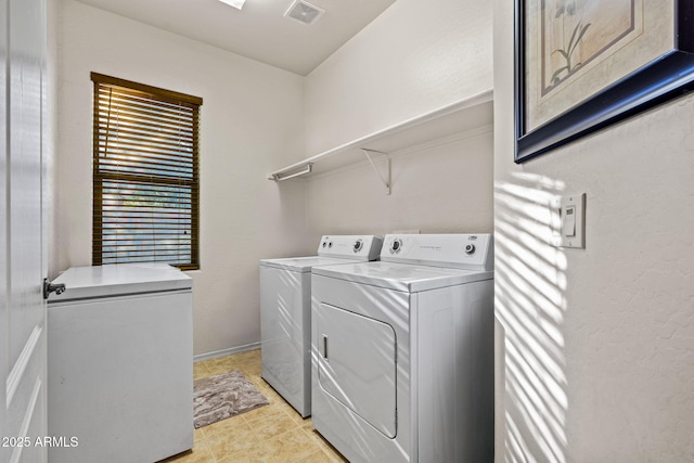 18057 W Port Royale Ln, Surprise, AZ 85388 - washroom with baseboards, washing machine and dryer, visible vents, and laundry area