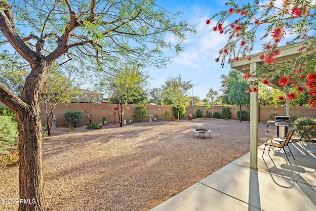 18057 W Port Royale Ln, Surprise, AZ 85388 - view of yard featuring a fenced backyard, a fire pit, and a patio