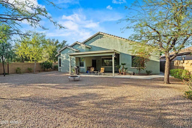 18057 W Port Royale Ln, Surprise, AZ 85388 - back of property with a patio, an outdoor fire pit, fence, and stucco siding