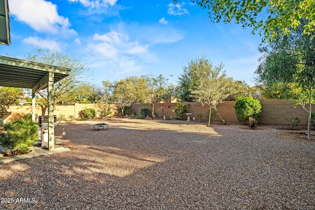 18057 W Port Royale Ln, Surprise, AZ 85388 - view of yard featuring an outdoor fire pit and a fenced backyard
