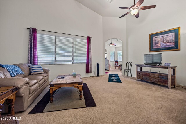 18057 W Port Royale Ln, Surprise, AZ 85388 - carpeted living room with a towering ceiling, visible vents, and ceiling fan
