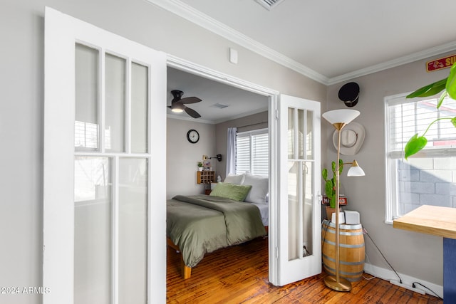 bedroom with hardwood / wood-style flooring, ceiling fan, and crown molding