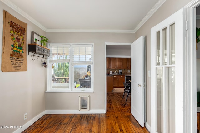 hall featuring dark hardwood / wood-style flooring and crown molding