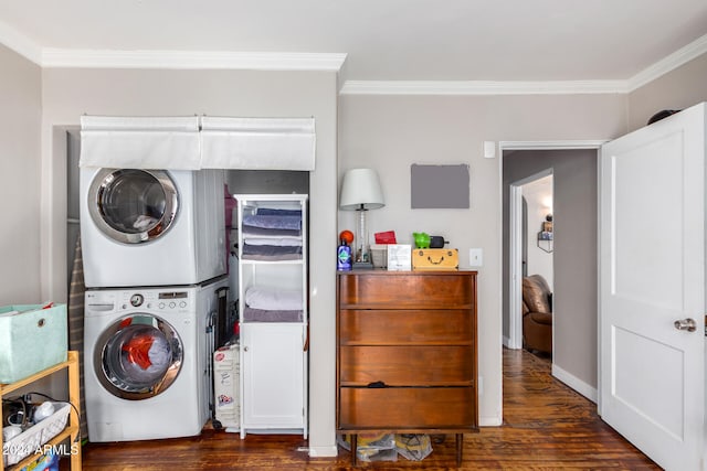 clothes washing area featuring dark wood-type flooring, stacked washer and dryer, and crown molding