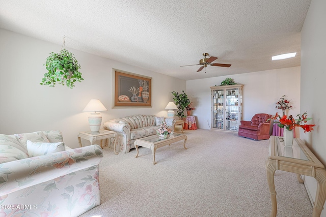 carpeted living room with ceiling fan and a textured ceiling