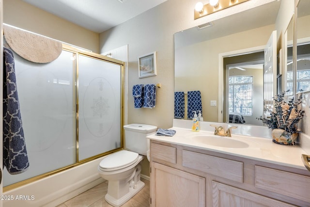 full bathroom featuring bath / shower combo with glass door, vanity, and toilet