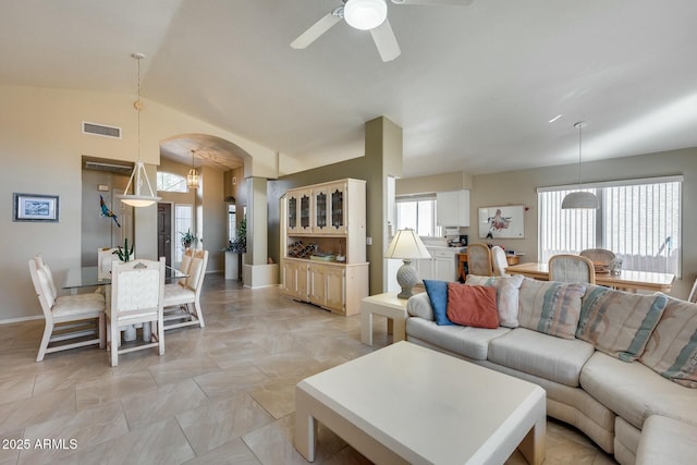 living room with ceiling fan and vaulted ceiling