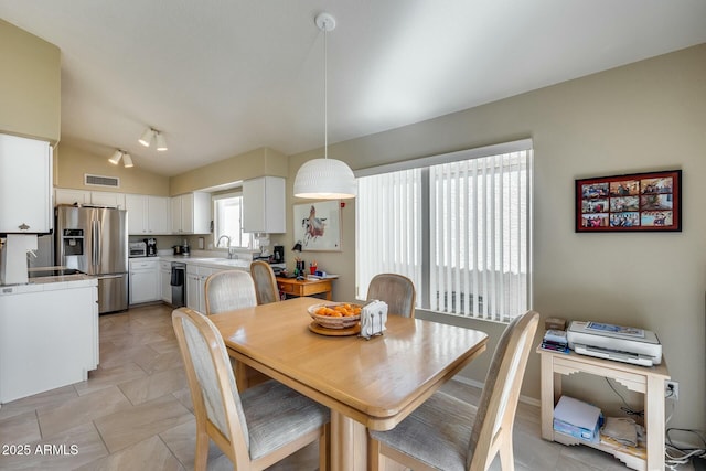 dining space with vaulted ceiling