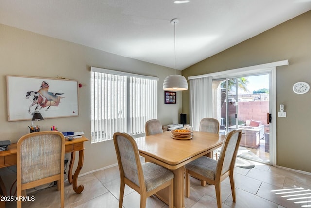 dining room featuring vaulted ceiling and light tile patterned flooring