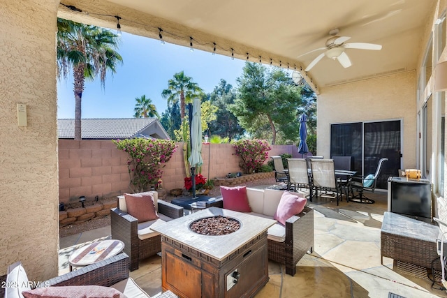 view of patio / terrace with an outdoor living space with a fire pit and ceiling fan