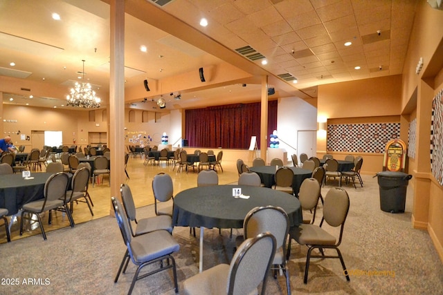 carpeted dining space with an inviting chandelier