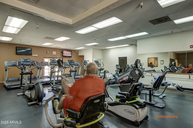 exercise room with a paneled ceiling