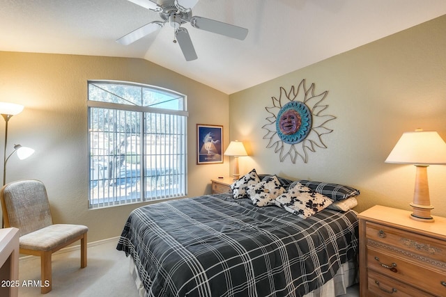 bedroom with ceiling fan, carpet flooring, vaulted ceiling, and multiple windows