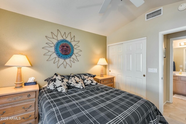 bedroom with vaulted ceiling, ensuite bathroom, ceiling fan, and a closet