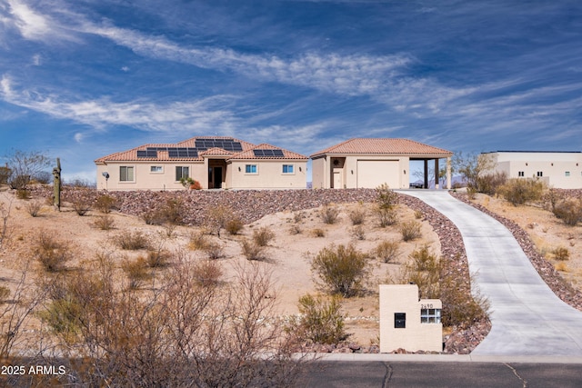 view of front of property with a garage and solar panels