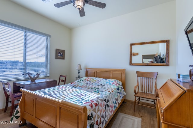 bedroom with ceiling fan and light hardwood / wood-style flooring