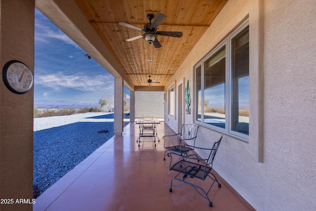 view of patio / terrace featuring a mountain view and ceiling fan