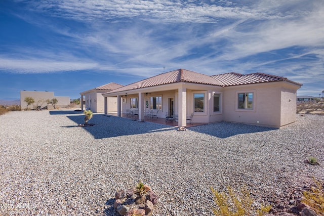 back of house with a patio