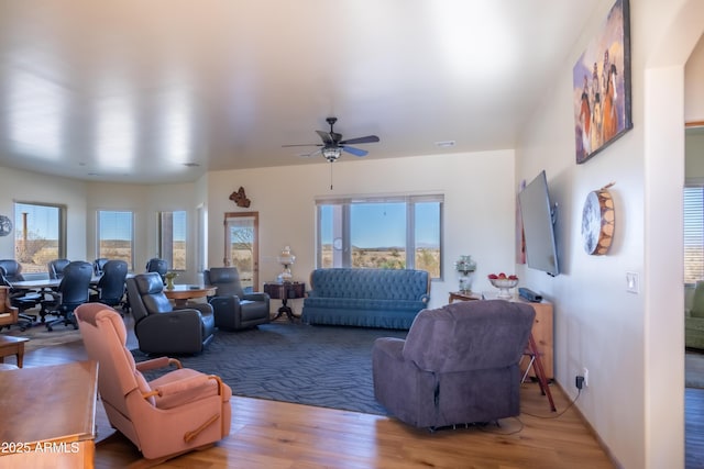 living room with ceiling fan and light hardwood / wood-style floors