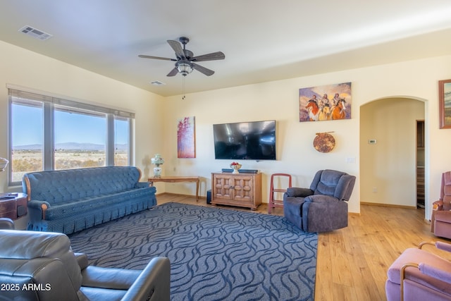 living room with hardwood / wood-style floors and ceiling fan