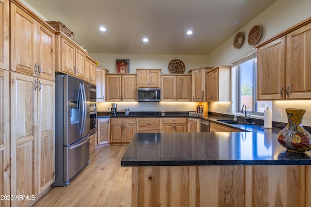 kitchen featuring light brown cabinets, sink, light hardwood / wood-style flooring, kitchen peninsula, and stainless steel appliances