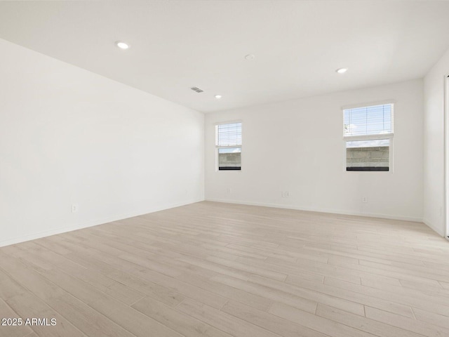 spare room with visible vents, baseboards, light wood-type flooring, and recessed lighting